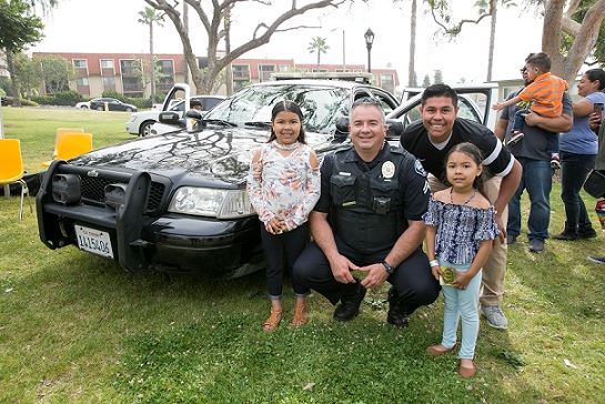 Officer with Kids at SpringFest with open police car